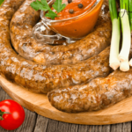 A table set with kielbasa and a variety of side dishes