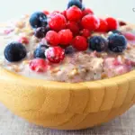 Heated overnight oats in a bowl with fresh toppings