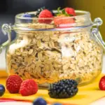 Wide-mouth mason jar filled with overnight oats and fresh berries on top