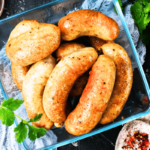 Chicken sausage cooking in a pan